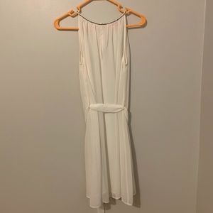 White dress with embellishments on the neckline.